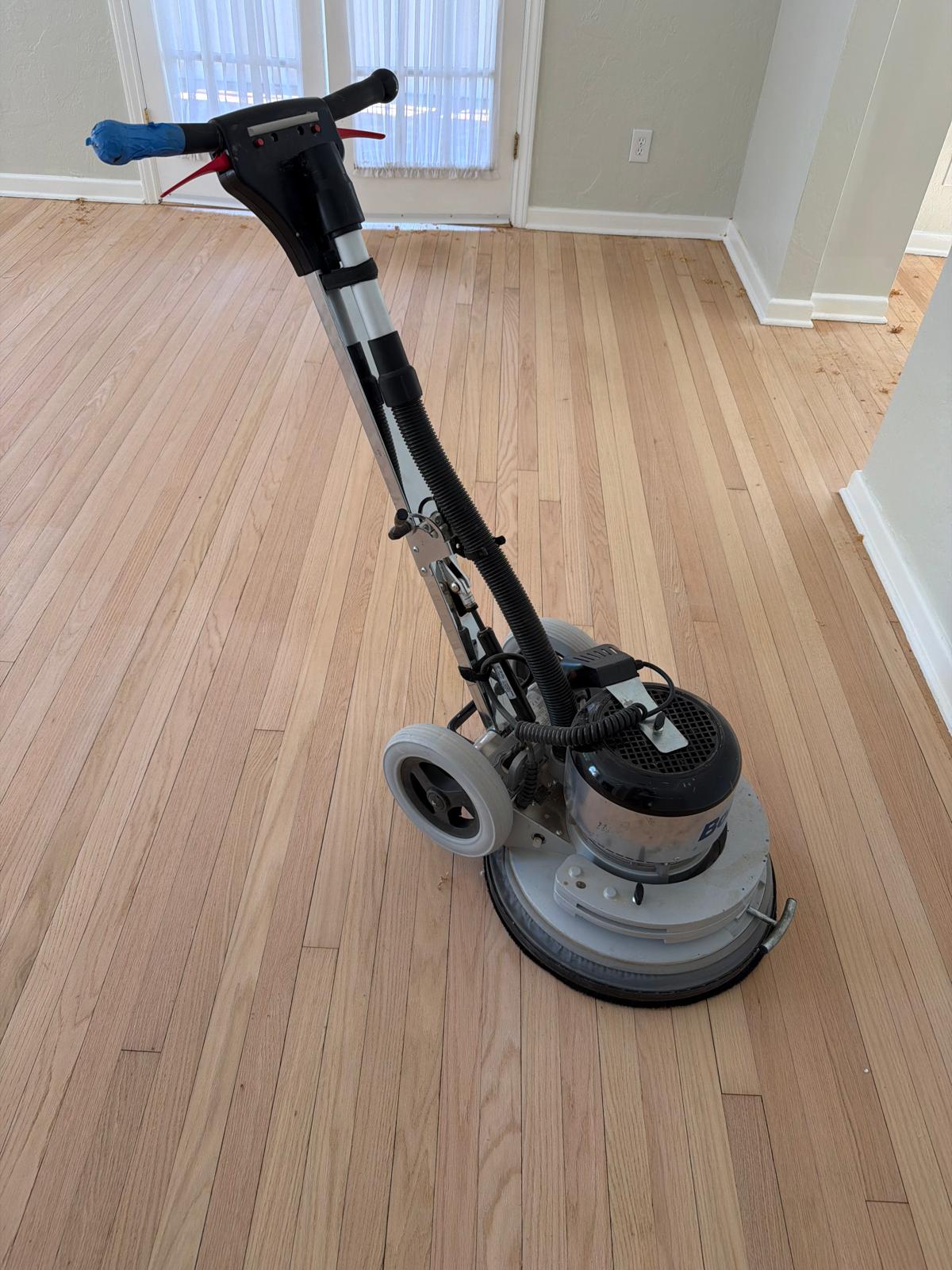 A skilled flooring craftsman in a beautifully finished room